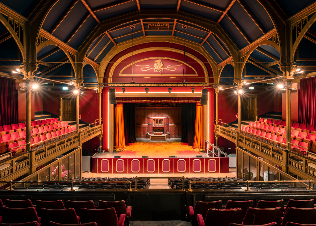 Photograph of the stage at Hartlepool Town Hall Theatre with red seats and red curtains
